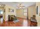 Cozy bedroom with hardwood floors, a ceiling fan, a large window, and comfortable seating at 17527 Stinchar Dr, Land O Lakes, FL 34638
