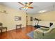 Bonus room includes hardwood floors, ceiling fan, and exercise equipment at 17527 Stinchar Dr, Land O Lakes, FL 34638