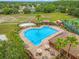 Aerial view of the resort-style swimming pool with splash pad and plenty of lounge seating at 17527 Stinchar Dr, Land O Lakes, FL 34638
