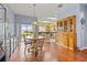 Bright dining area with hardwood floors, and views into the kitchen and through sliding glass doors at 17527 Stinchar Dr, Land O Lakes, FL 34638