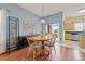 Dining area with hardwood floors, decorative lighting, and sliding glass doors at 17527 Stinchar Dr, Land O Lakes, FL 34638