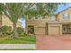 Charming two-story townhome featuring an attached two-car garage and a brick paved driveway at 17527 Stinchar Dr, Land O Lakes, FL 34638