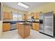 Bright eat-in kitchen features an island, stainless steel appliances, and granite countertops at 17527 Stinchar Dr, Land O Lakes, FL 34638