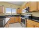 This kitchen boasts granite countertops, stainless appliances, and wood cabinetry at 17527 Stinchar Dr, Land O Lakes, FL 34638