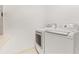 Bright laundry room featuring modern washer and dryer units at 17527 Stinchar Dr, Land O Lakes, FL 34638
