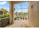 Screened patio overlooking a peaceful lake with lush landscaping at 17527 Stinchar Dr, Land O Lakes, FL 34638