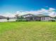 The backyard of the home features a bright green lawn and a crisp white fence at 18079 Romanesque Ct, Spring Hill, FL 34610