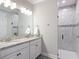 Bright bathroom showcasing a granite countertop vanity and walk-in shower with decorative tiling at 18079 Romanesque Ct, Spring Hill, FL 34610