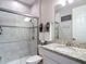 Bathroom with a glass-enclosed shower, granite countertop, and white vanity at 18079 Romanesque Ct, Spring Hill, FL 34610