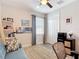 Cozy bedroom featuring a comfortable sofa, workspace, and ample natural light at 18079 Romanesque Ct, Spring Hill, FL 34610