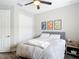 Bedroom featuring a queen bed, a closet with white doors, and neutral-colored walls at 18079 Romanesque Ct, Spring Hill, FL 34610