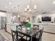 Open floor plan showcasing kitchen island to dining and living area with modern decor and natural light at 18079 Romanesque Ct, Spring Hill, FL 34610