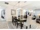Formal dining room with a modern chandelier, a large wooden table, and comfortable seating, perfect for gatherings at 18079 Romanesque Ct, Spring Hill, FL 34610