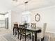 Elegant dining room featuring a modern chandelier, complemented by neutral walls and stylish decor at 18079 Romanesque Ct, Spring Hill, FL 34610
