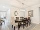 Formal dining room with a modern chandelier, a wooden table, and comfortable seating, perfect for entertaining at 18079 Romanesque Ct, Spring Hill, FL 34610