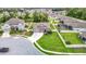 Aerial view of a well-maintained home with lush lawn, three car garage, and manicured landscaping at 18079 Romanesque Ct, Spring Hill, FL 34610