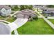 A charming single-story home featuring a well-manicured lawn, three-car garage, and stone accents at 18079 Romanesque Ct, Spring Hill, FL 34610