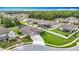 Home features an extra long driveway, lush lawn, and a well-manicured front yard in this aerial shot at 18079 Romanesque Ct, Spring Hill, FL 34610
