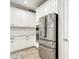 Beautiful kitchen with white cabinets, stainless steel appliances, subway tile backsplash, and wood-look floors at 18079 Romanesque Ct, Spring Hill, FL 34610
