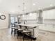 Bright, modern kitchen with white cabinetry, granite countertops, a large island, and stainless steel appliances at 18079 Romanesque Ct, Spring Hill, FL 34610