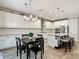 Modern kitchen featuring white cabinetry, stainless steel appliances, and a center island with seating at 18079 Romanesque Ct, Spring Hill, FL 34610