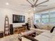 Comfortable living room with large sectional sofa, entertainment center, and natural light at 18079 Romanesque Ct, Spring Hill, FL 34610