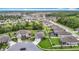 Aerial view of new homes in a suburban neighborhood featuring lush landscaping and community ponds at 18079 Romanesque Ct, Spring Hill, FL 34610