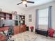 Office featuring a wooden built-in desk, a ceiling fan, and a window overlooking the neighborhood at 18079 Romanesque Ct, Spring Hill, FL 34610