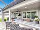 Covered outdoor kitchen and bar area with view of the backyard at 18079 Romanesque Ct, Spring Hill, FL 34610