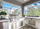 Outdoor kitchen with stainless steel grill, sink and bar at 18079 Romanesque Ct, Spring Hill, FL 34610