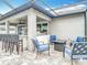 Covered patio featuring multiple seating areas, a bar, and outdoor kitchen at 18079 Romanesque Ct, Spring Hill, FL 34610