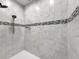 Tiled shower with dual shower heads and decorative accent tiles at 18079 Romanesque Ct, Spring Hill, FL 34610