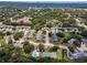 Expansive aerial view shows the community's layout, with tree-lined streets and various amenities at 184 Hunter Ct, Palm Harbor, FL 34684