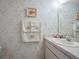 Powder room with floral wallpaper and decorative hand towels at 184 Hunter Ct, Palm Harbor, FL 34684