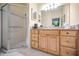 Bathroom featuring a glass door shower, a mirror, and a light wood vanity at 184 Hunter Ct, Palm Harbor, FL 34684