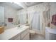 Bathroom with a decorative shower curtain and vintage wallpaper at 184 Hunter Ct, Palm Harbor, FL 34684