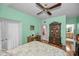 Bright bedroom showcasing a decorative bed frame, ceiling fan, and access to bathroom at 184 Hunter Ct, Palm Harbor, FL 34684