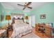 Bright bedroom featuring a decorative bed frame, a ceiling fan, and a vintage desk at 184 Hunter Ct, Palm Harbor, FL 34684
