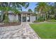 Community pool entrance featuring a gate, surrounding trees, and a paved walkway at 184 Hunter Ct, Palm Harbor, FL 34684
