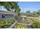 Community entrance sign with lush landscaping and a fountain feature at 184 Hunter Ct, Palm Harbor, FL 34684