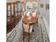 Dining room with chandelier, hutch, floral carpet, and bright windows at 184 Hunter Ct, Palm Harbor, FL 34684