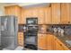 Stainless steel refrigerator and granite countertops in modern eat-in kitchen at 184 Hunter Ct, Palm Harbor, FL 34684