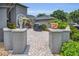 Brick patio with outdoor seating, grill, potted plants, and gray privacy walls at 184 Hunter Ct, Palm Harbor, FL 34684