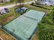 Aerial view of tennis court featuring a pond and manicured landscaping at 184 Hunter Ct, Palm Harbor, FL 34684