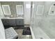 Updated bathroom featuring a double sink vanity, tiled walls, and glass-enclosed shower at 1842 Ridgelake Ct, Wesley Chapel, FL 33543
