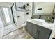 Modern bathroom featuring a gray vanity, white countertops, and a sleek glass shower that adds a touch of elegance to the space at 1842 Ridgelake Ct, Wesley Chapel, FL 33543