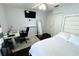 Cozy bedroom featuring hardwood floors, desk, and a queen bed with white linens at 1842 Ridgelake Ct, Wesley Chapel, FL 33543
