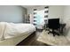 Bedroom with hardwood floors featuring a desk, chair, and shelving near a bright window at 1842 Ridgelake Ct, Wesley Chapel, FL 33543