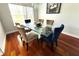 Stylish dining room with a glass-top table, upholstered chairs, and hardwood floors at 1842 Ridgelake Ct, Wesley Chapel, FL 33543