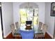 Bright dining area with a glass table, seating for six, wood floors, and chandelier lighting at 1842 Ridgelake Ct, Wesley Chapel, FL 33543
